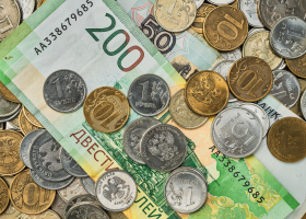 Money, coins and banknotes in Russian rubles scattered in a heap on the table, top view. Idea for background or banner for market news