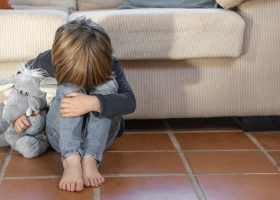 little-boy-outdoors-upset-holding-his-toy