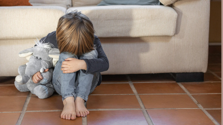 little-boy-outdoors-upset-holding-his-toy