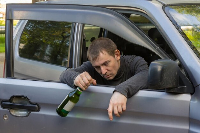 drunk-driver-with-bottle-alcohol-sleeping-door-his-own-car_1048944-8504666