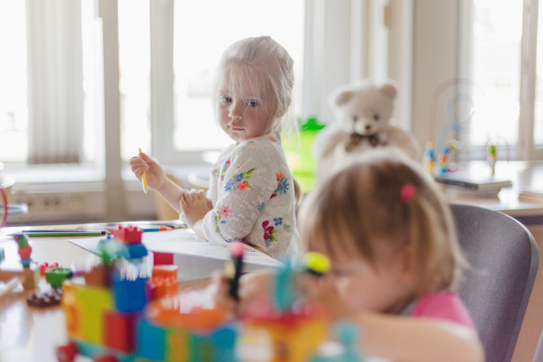 little-girl-drawing-sitting-table